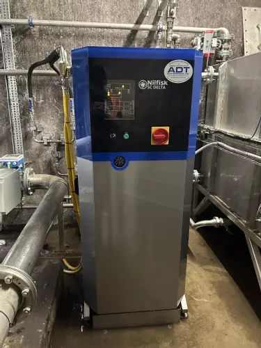 Delta booster pressure washer unit installed to supply multiple high- and low-pressure wash points at an industrial site in Burton.